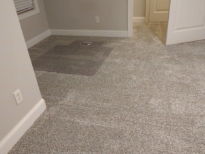 A bedroom featuring newly installed grey carpet by Faith and Grace Flooring, a carpet contractor in Murfreesboro, TN.