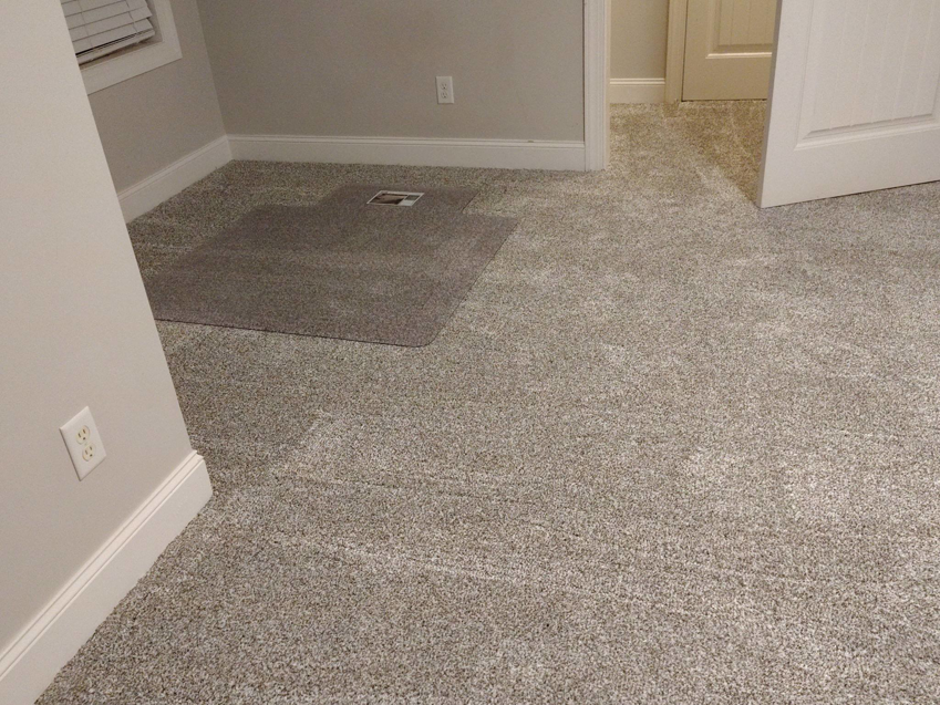 A bedroom featuring newly installed grey carpet by Faith and Grace Flooring, a carpet contractor in Murfreesboro, TN.