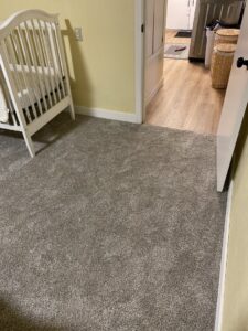 Newly installed grey carpet in a bedroom, showcasing a completed carpet contractor job by Idaho Floors in Meridian, ID.