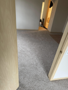 Newly installed grey carpet in a residential room by La 23 floors an more in Janesville, WI.