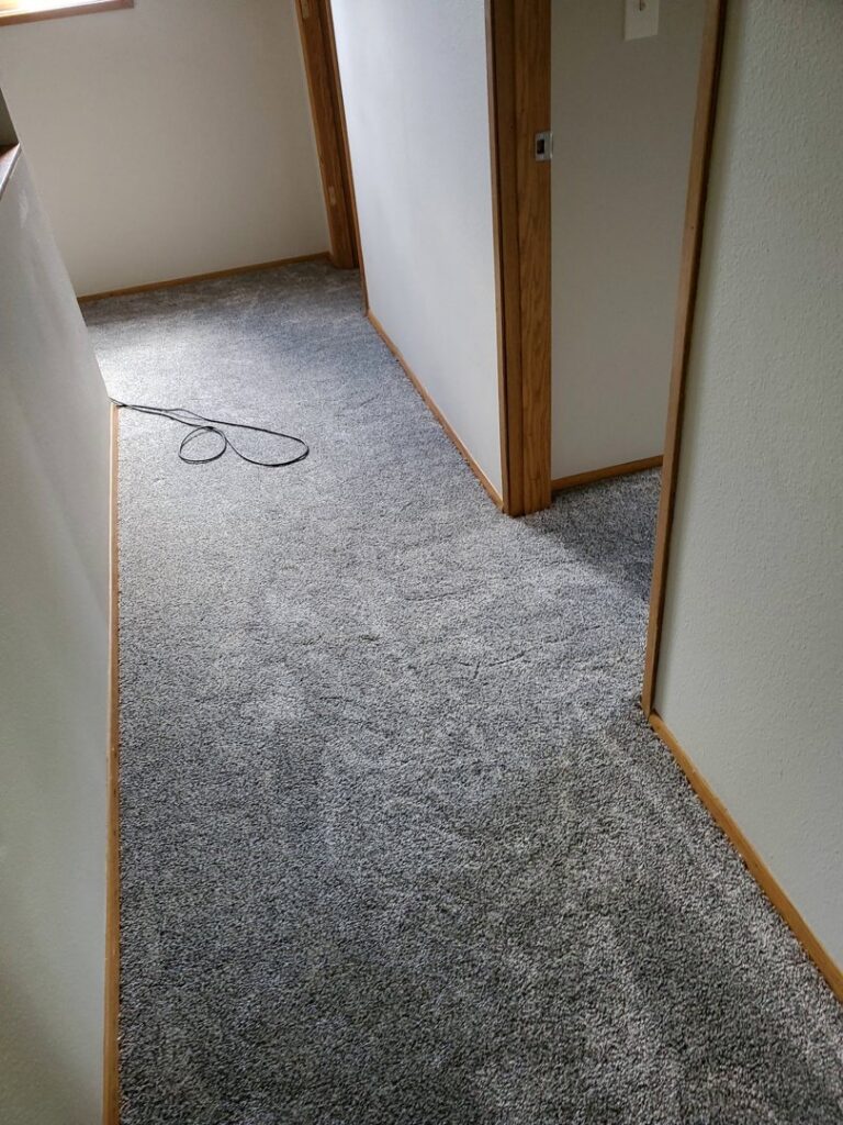 Newly installed grey carpet in a hallway by Columbia Flooring Group in Troutdale, OR