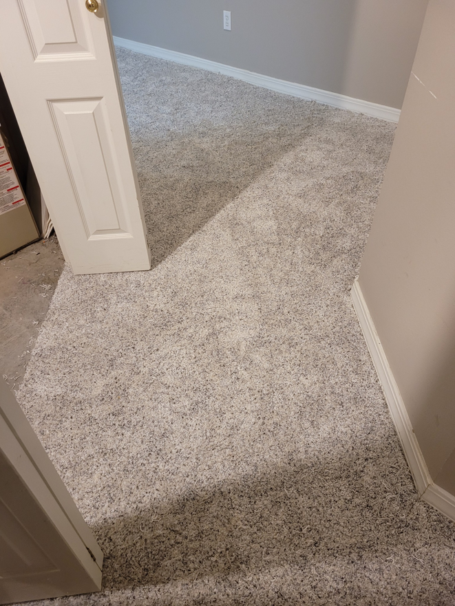 Newly installed light grey carpet in a hallway by Rendon Flooring in Green River, WY.