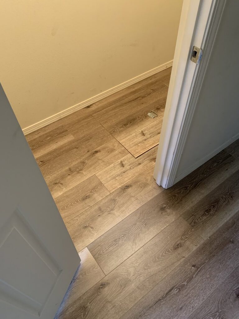 Newly installed hardwood flooring in a bright living room by Carpet USA in Vancouver, WA.