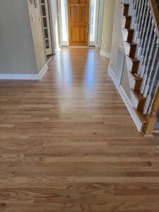 Newly installed hardwood flooring in a home entryway and hallway by Augusta Carpet Mart in Augusta, GA.
