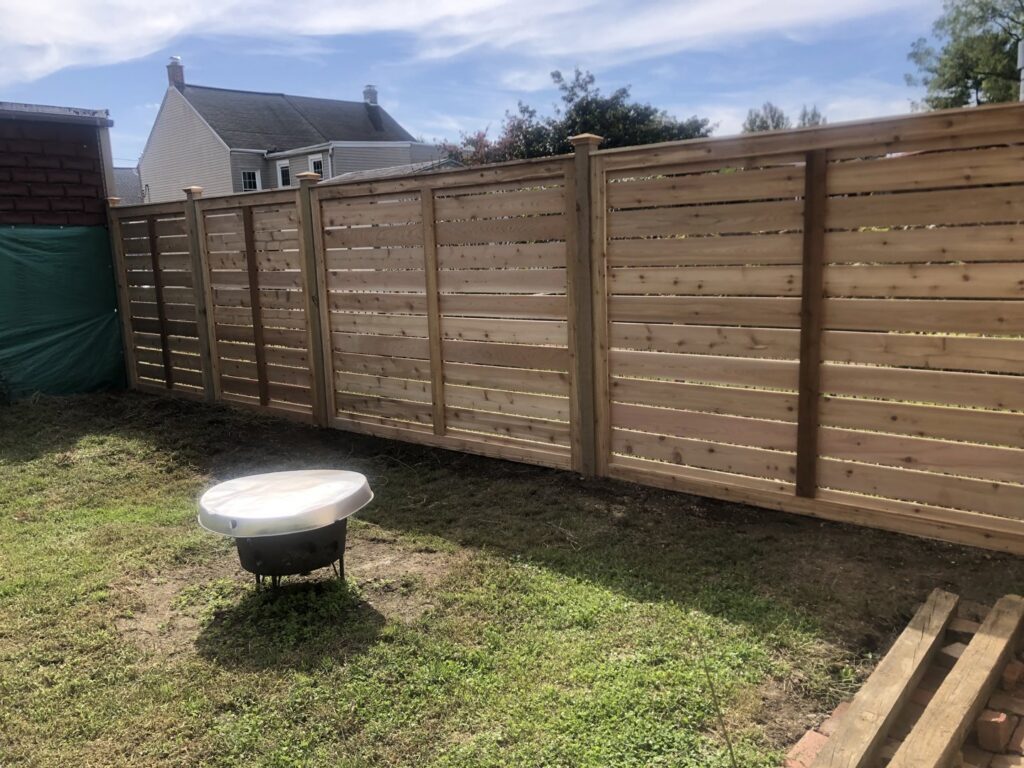 A newly installed modern horizontal wood slat fence by Integrous, a fencing contractor in Gap, PA
