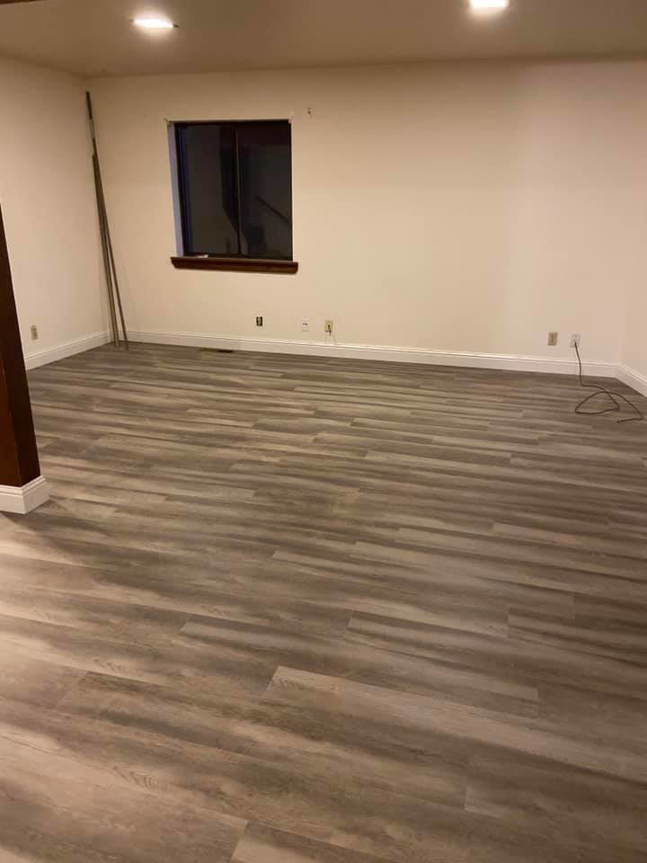Newly installed laminate or vinyl plank flooring in a room by Carpet Club in Escondido, CA