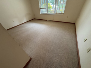 A newly installed light brown carpet in an empty room by CDK Flooring, LLC in Sheboygan, WI.