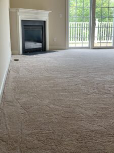 Newly installed light brown carpet in a living room by Seaford Flooring in Seaford, DE.