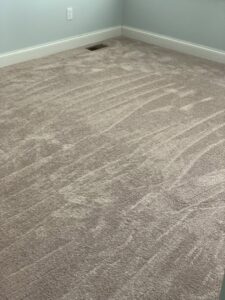 A newly installed light brown carpet in a room, showcasing a completed job by Seaford Flooring in Seaford, DE.