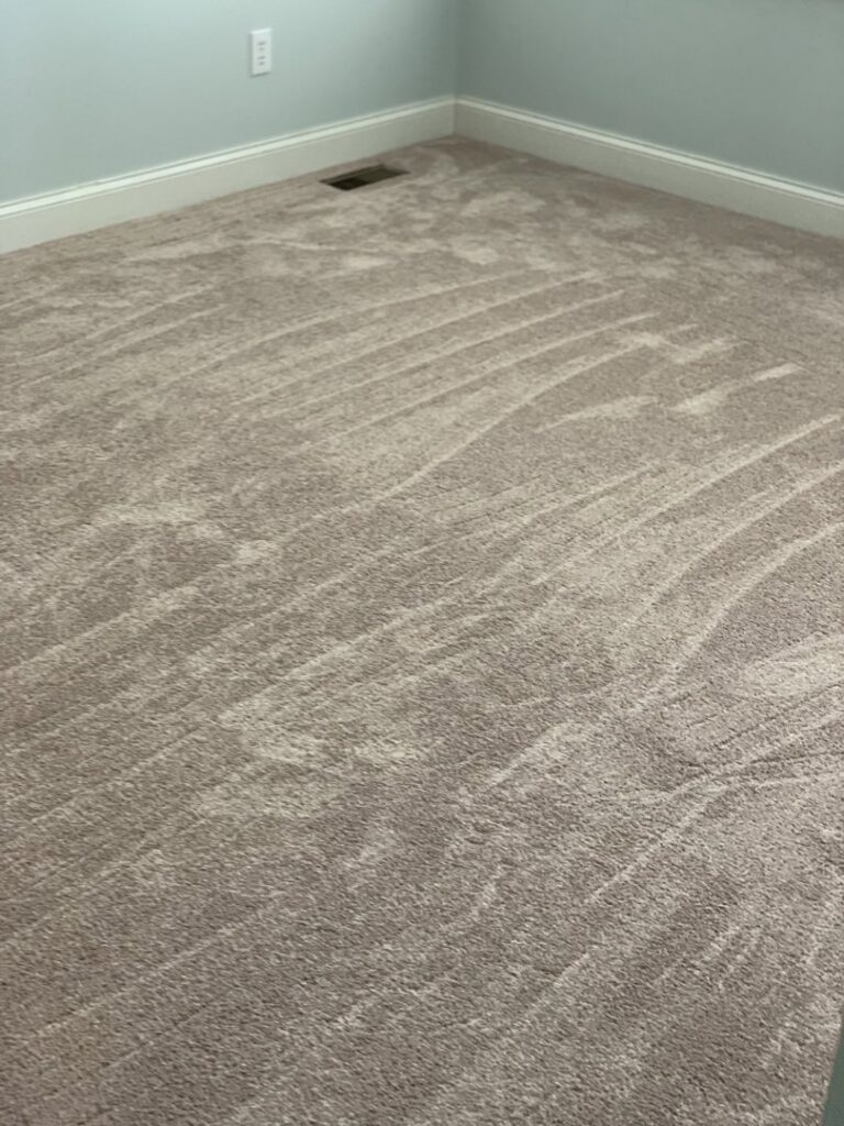 A newly installed light brown carpet in a room, showcasing a completed job by Seaford Flooring in Seaford, DE.