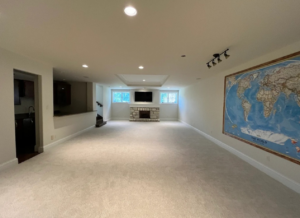 A newly installed light-colored carpet in a spacious basement living area by Veteran Flooring STL in Maryland Heights, MO.