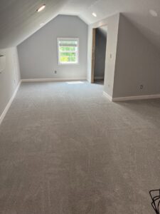 Newly installed light grey carpet in an attic room by Seaford Flooring in Seaford, DE.