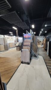 A bright bedroom showcasing newly installed light grey carpet by Dalton Wholesale in Adairsville, GA.