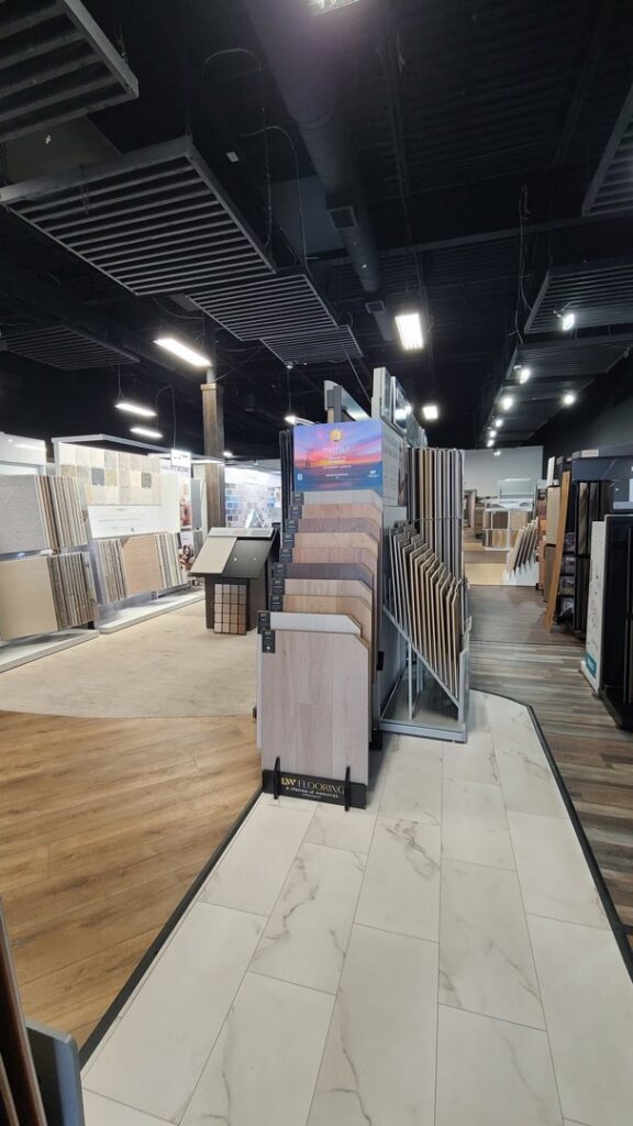 A bright bedroom showcasing newly installed light grey carpet by Dalton Wholesale in Adairsville, GA.