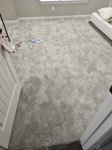 A newly installed light grey carpet in a bedroom by Don's Floor Gallery in Edmond, OK.