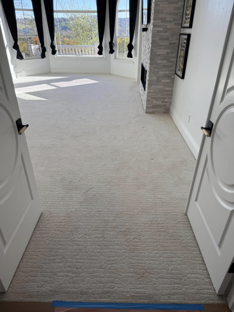 A spacious room featuring newly installed light-colored textured carpet by EDC Flooring inc in Sacramento, CA