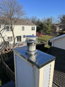 A newly installed metal chimney cap on a residential chimney, showcasing services by A Sweep Across the Bay in Parrish, FL.