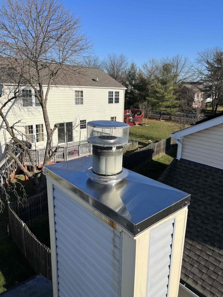A newly installed metal chimney cap on a residential chimney, showcasing services by A Sweep Across the Bay in Parrish, FL.