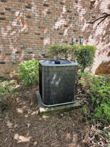 A newly installed outdoor AC unit next to a brick wall, completed by Faith Heat and Cool in West Monroe, LA
