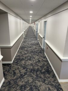 A long hallway featuring newly installed patterned carpet, a completed project by Anaheim Carpet and Flooring in Anaheim, CA.