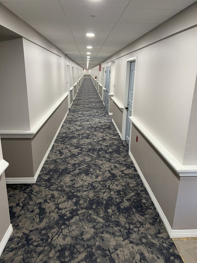 A long hallway featuring newly installed patterned carpet, a completed project by Anaheim Carpet and Flooring in Anaheim, CA.