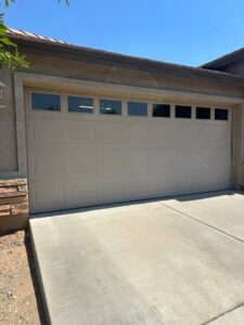 A newly installed or repaired residential garage door with windows, showcasing work by Central Garage Door Repair LLC in Glendale, AZ.