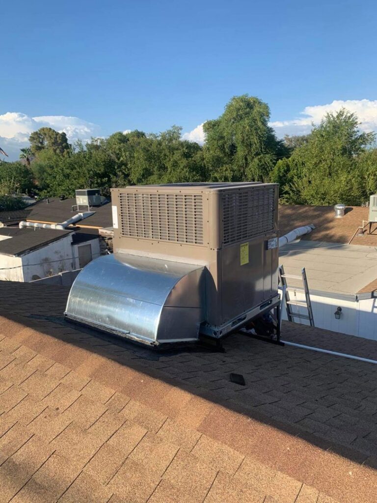 A newly installed rooftop HVAC unit with connected ductwork on a residential roof by BH cooling & Heating in Glendale, AZ.