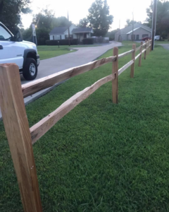 A newly installed split-rail wood fence along a residential street by Fence Masters Upstate SC in Greenville, SC