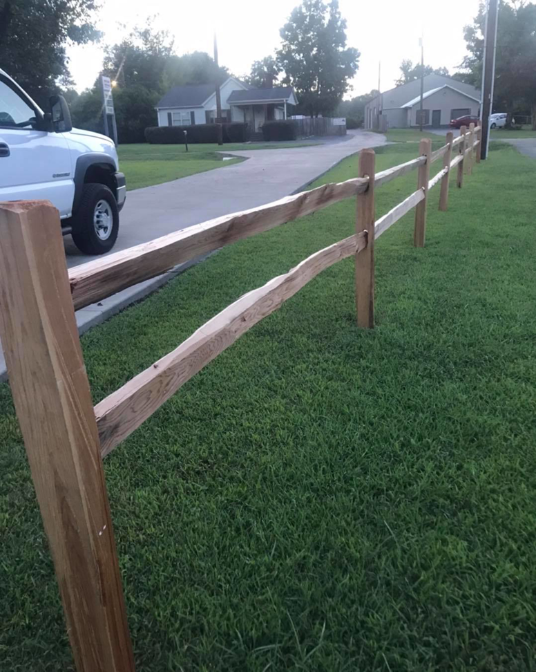 A newly installed split-rail wood fence along a residential street by Fence Masters Upstate SC in Greenville, SC