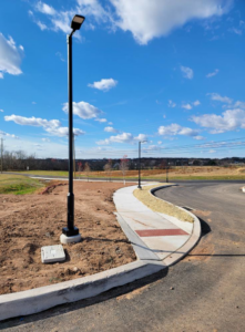 A newly installed LED street light and electrical box on a sunny day by BESTA in Perkasie, PA.