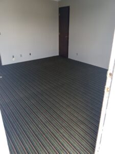 A room featuring newly installed striped carpet by Medina's Floor Covering Inc. in Yakima, WA.
