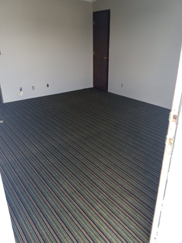 A room featuring newly installed striped carpet by Medina's Floor Covering Inc. in Yakima, WA.