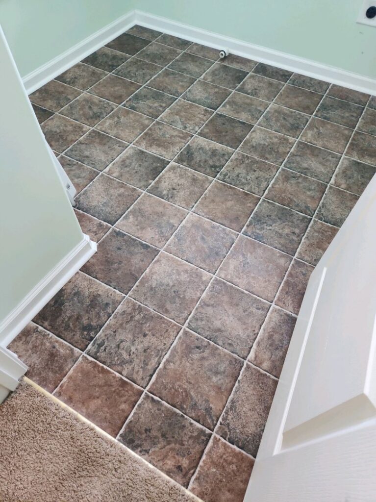 Newly installed tile flooring in a small hallway or utility area by Augusta Carpet Mart in Augusta, GA.