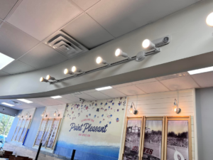 Newly installed track lighting and decorative wall sconces in a commercial setting by Solution Electric in Houston, TX.