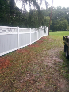 A newly installed two-tone vinyl fence with lattice top, showcasing a Fencing Contractor job by Fence Fair in Baltimore, MD.