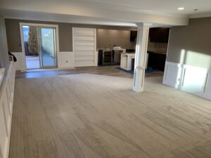 A spacious room featuring newly installed wall-to-wall carpet by AguirreFloorz in Colorado Springs, CO.