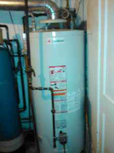 A newly installed water heater in a utility room by Cheaper Plumbing & Heating in Lansing, MI