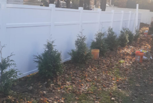 A newly installed white vinyl privacy fence by D & G'S Maintenance LLC in Woonsocket, RI.