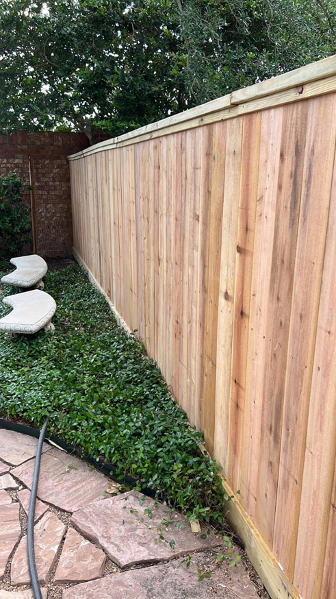 A newly installed wooden privacy fence in a backyard by Alexi's Handyman Services in Indianapolis, IN.
