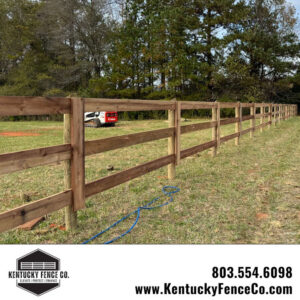 A newly installed wooden fence with a skid steer in the background by Kentucky Fence Co in McConnells, SC.