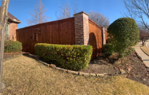 A newly installed wood fence with decorative brick pillars by 3M Custom Fence in Lewisville, TX.