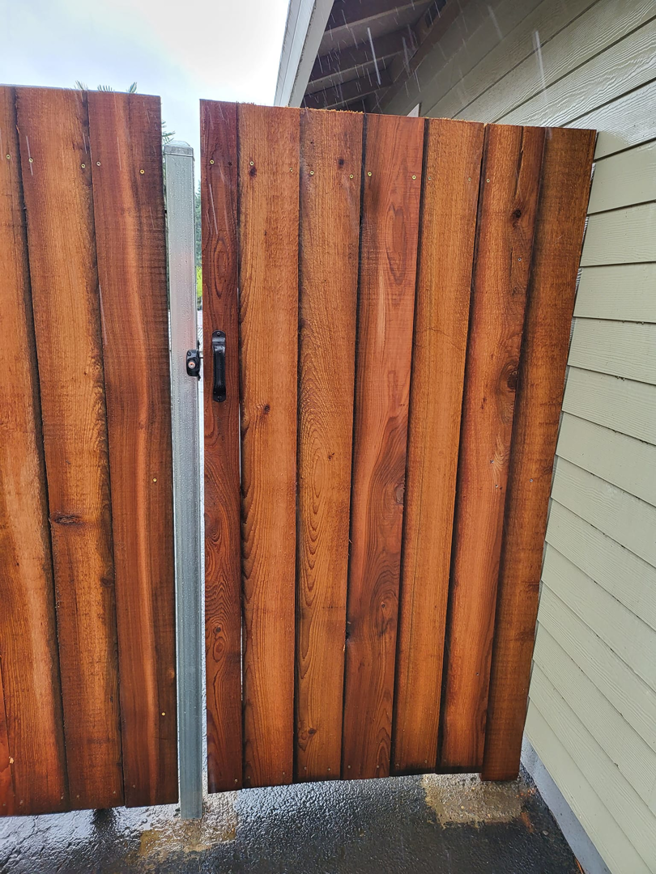 A newly installed wooden gate with a black handle, completed by Jones NW Fence Company in Vancouver, WA.