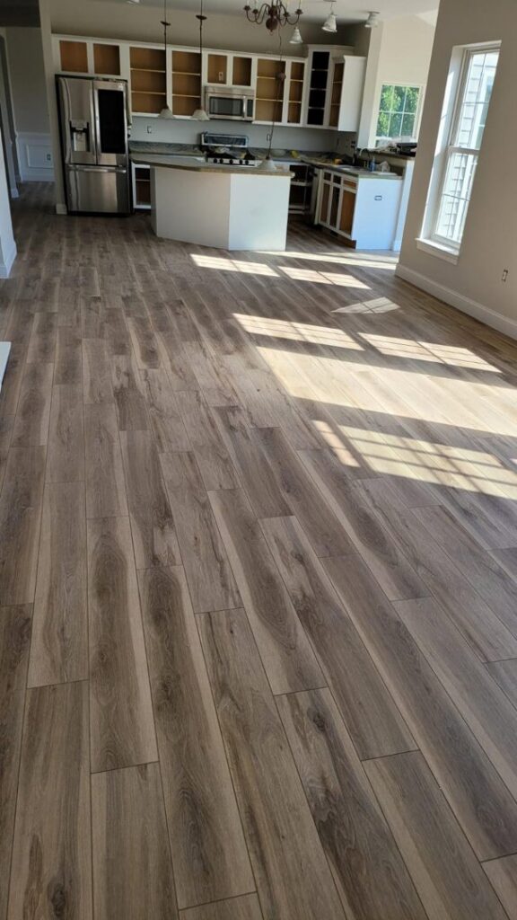 A room showcasing newly installed wood-look plank flooring by Jerry's Carpet Sales and Service in York, PA.