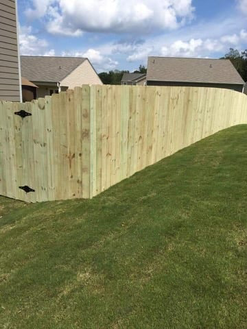 A newly installed wood privacy fence in a residential backyard by Castillo Fences in Sacramento, CA.