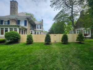A newly installed wood privacy fence separating two large residential properties by City Fence Inc. in Lancaster, NY.