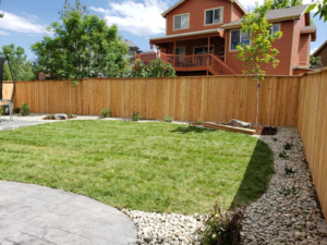 A newly installed wood privacy fence enclosing a residential backyard, completed by JBC Services LLC in Milwaukee, WI.