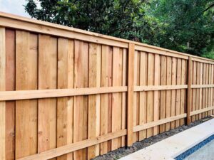 A newly installed wood privacy fence next to a patio or pool area by KY Fencing Unlimited in Louisville, KY.