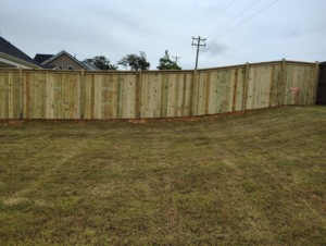 A newly installed wood privacy fence in a residential backyard by Maine Wood Fencing & more in Greenville, SC.