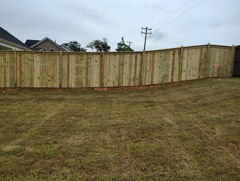 A newly installed wood privacy fence in a residential backyard by Maine Wood Fencing & more in Greenville, SC.