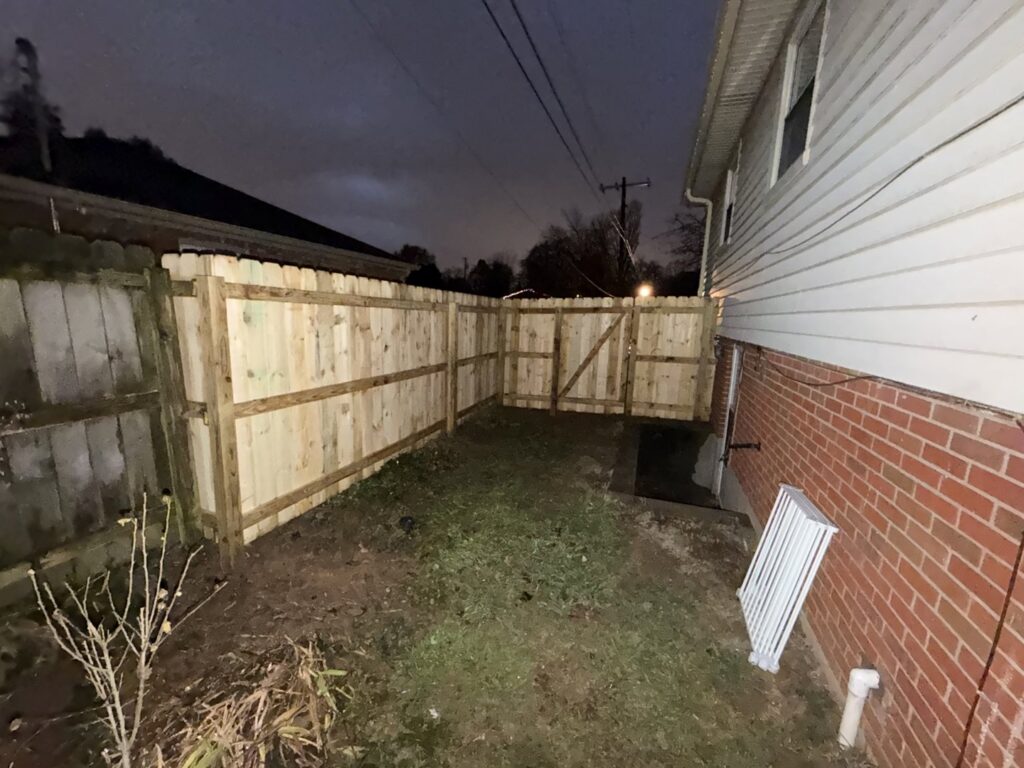 A newly installed wood privacy fence in a residential backyard by Raatz Fence Company in Louisville, KY.
